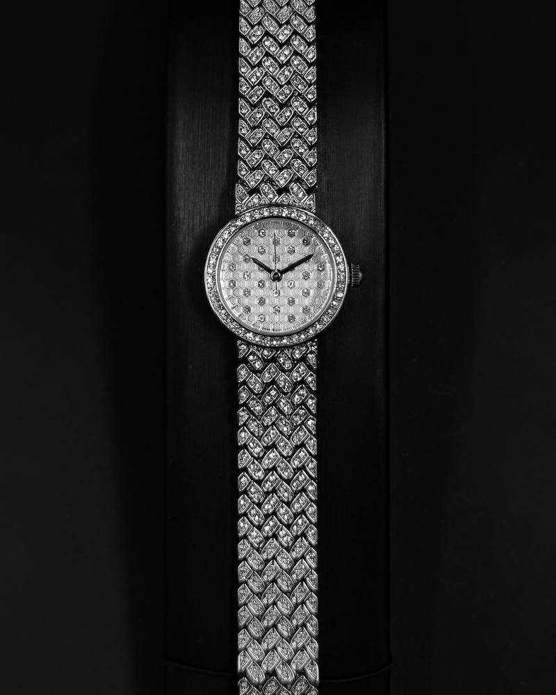 Silver wristwatch with a round dial and a wide strap