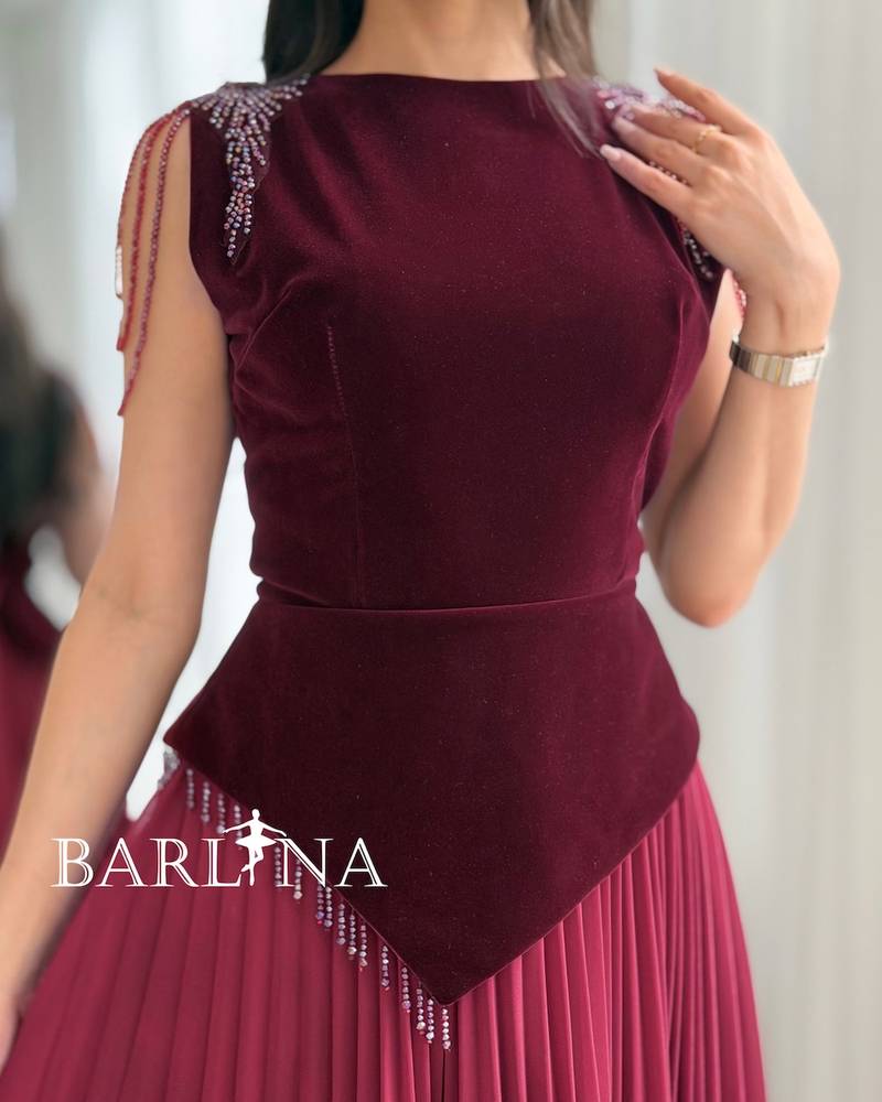 A burgundy dress with a velvet top and a slanted waist.