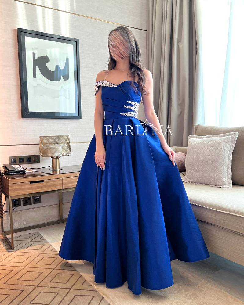 Long blue dress embroidered with crystals