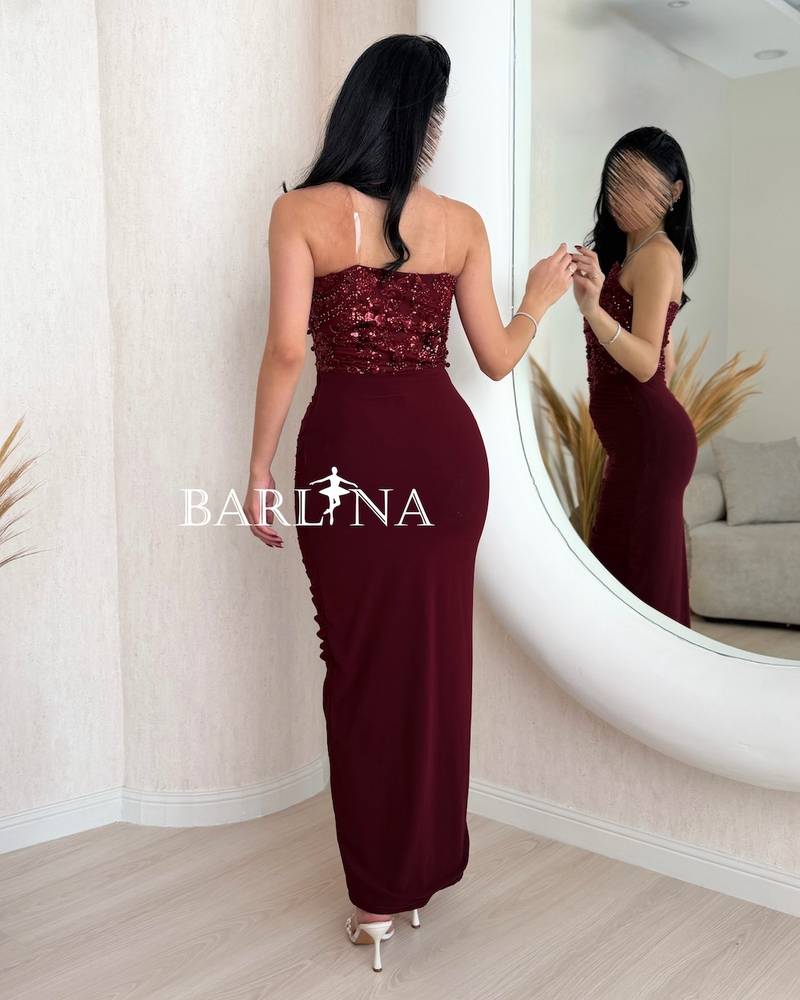 Burgundy dress with a front slit and a gathered design