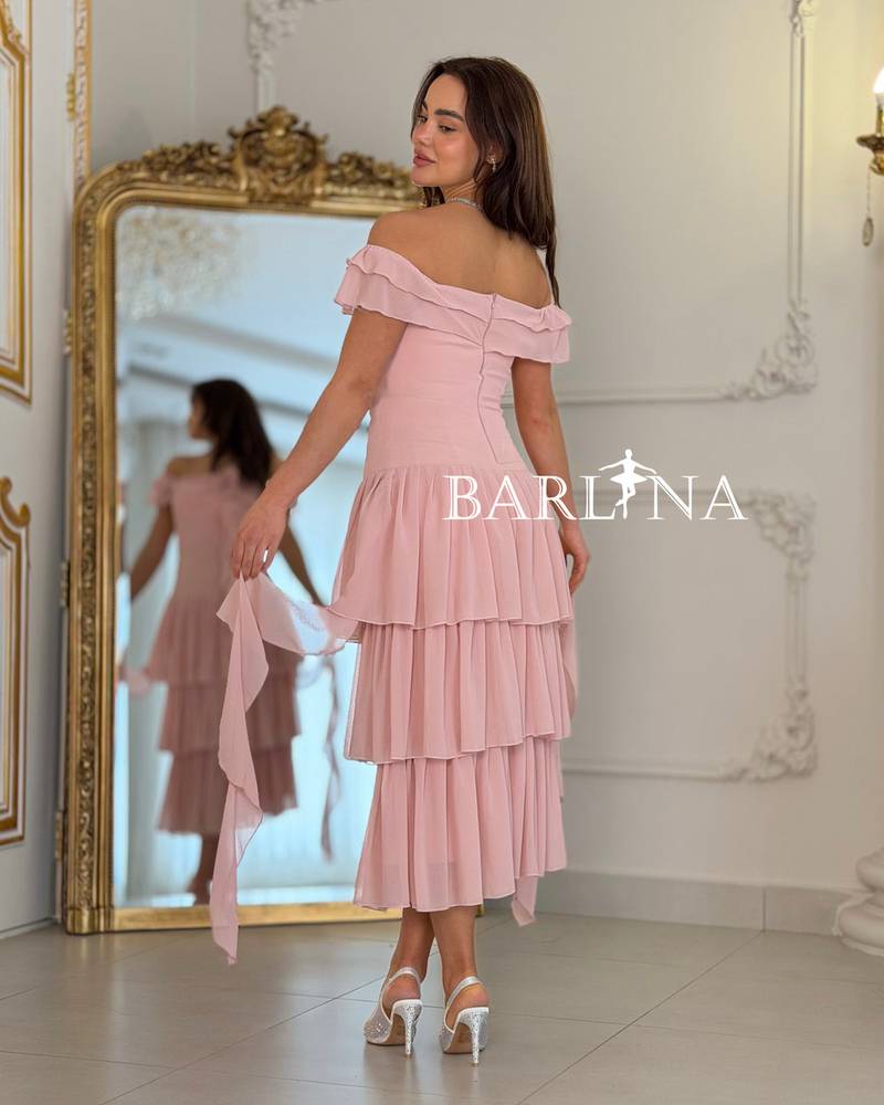 A soft, layered dress with a fabric rose.