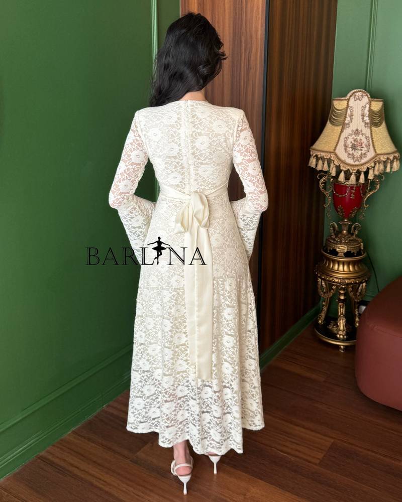 An elegant off-white dress with long sleeves