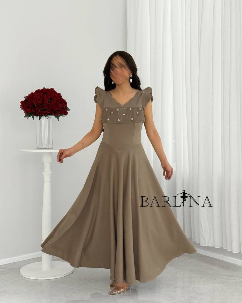 A soft, mocha-colored dress with a wide, embellished cut