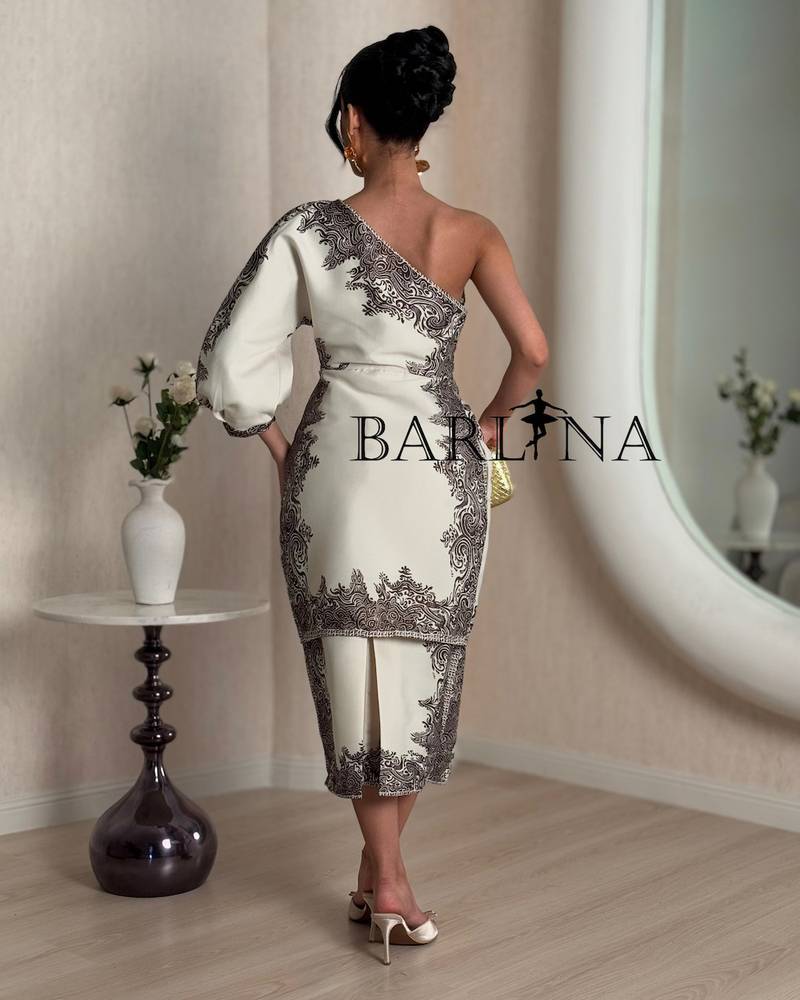 A distinctive one-shoulder dress with decorative patterns