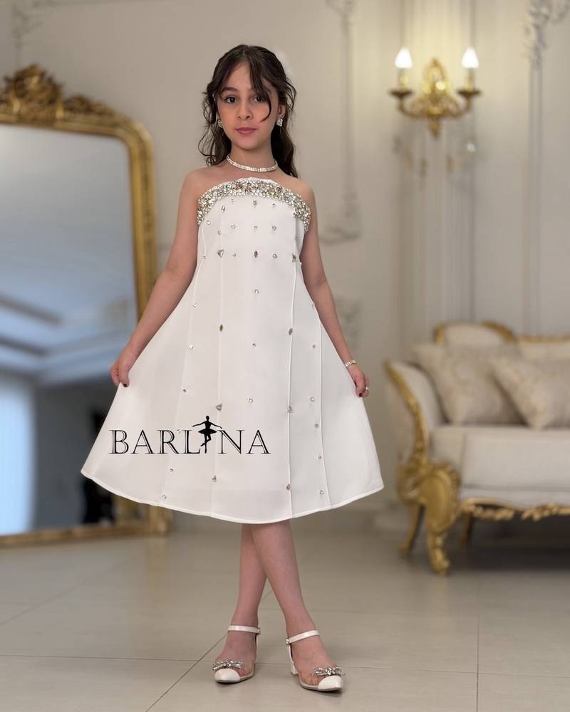 White girl's dress decorated with crystal details