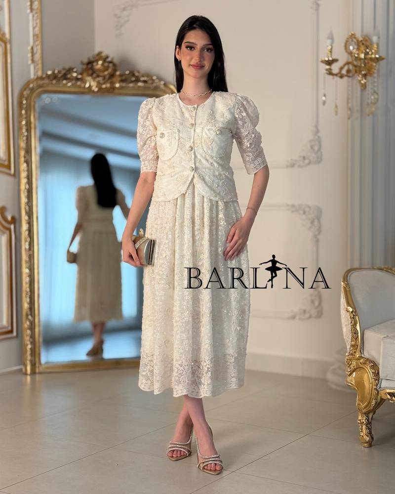 A two-piece off-white dress with an elegant lace design