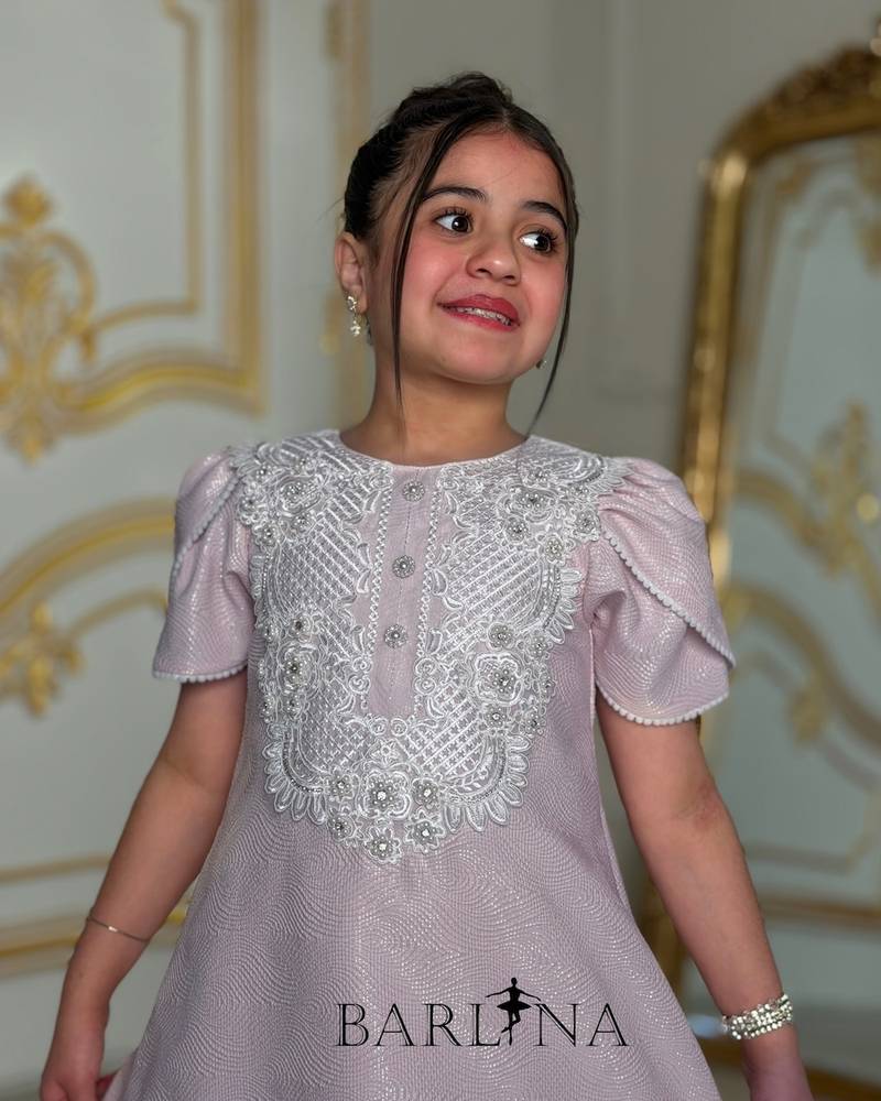 Light mauve girls' dress with white patterns on the chest