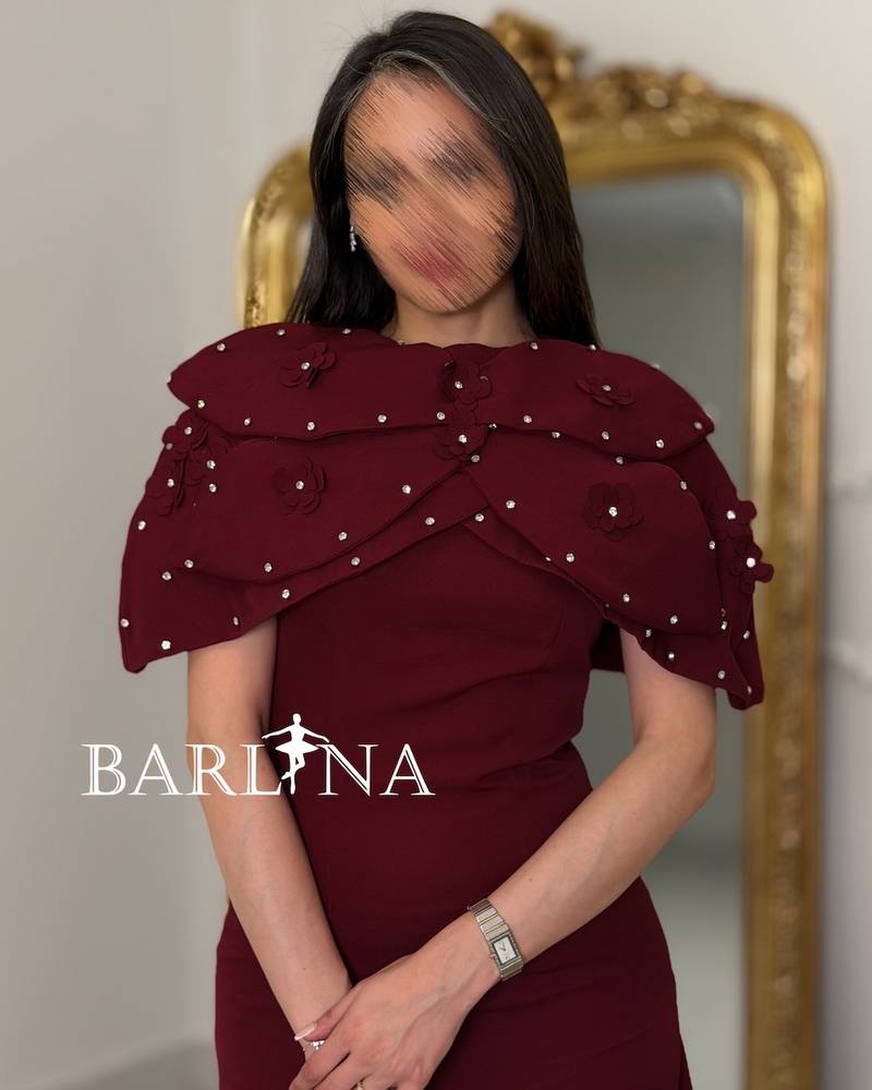 Burgundy dress with a pearl-embellished shoulder piece