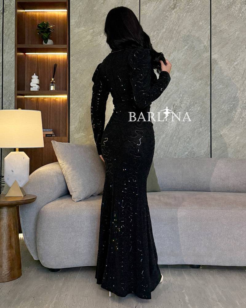 Black embroidered dress with shiny touches and a side slit