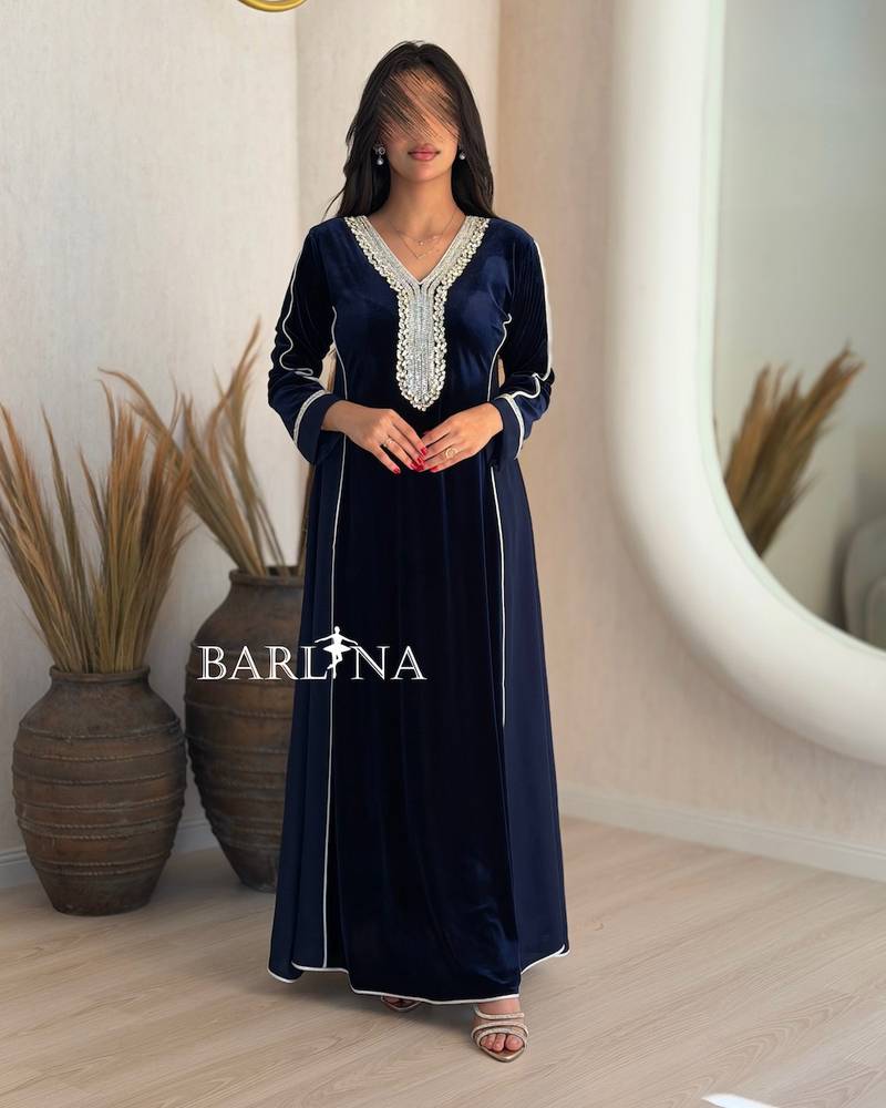 A navy blue flared jalabiya decorated with crystals