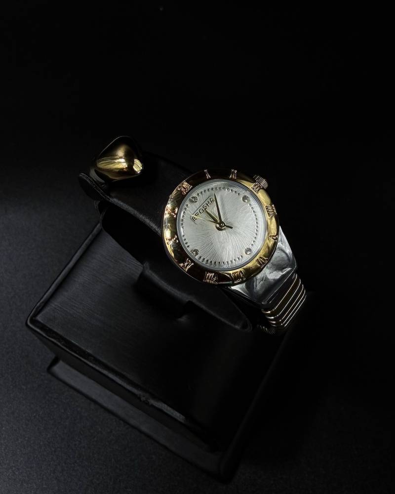 A women's watch with a delicate design and an open strap.