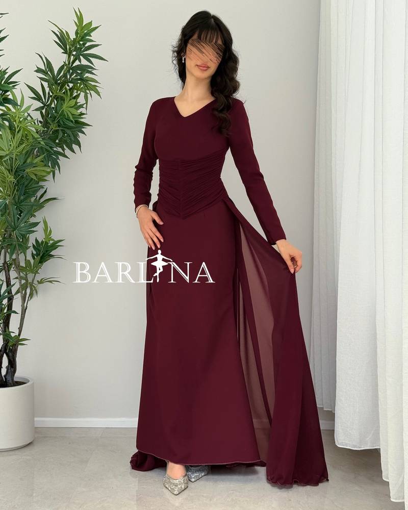 Dark burgundy dress with a gathered hem and a light train