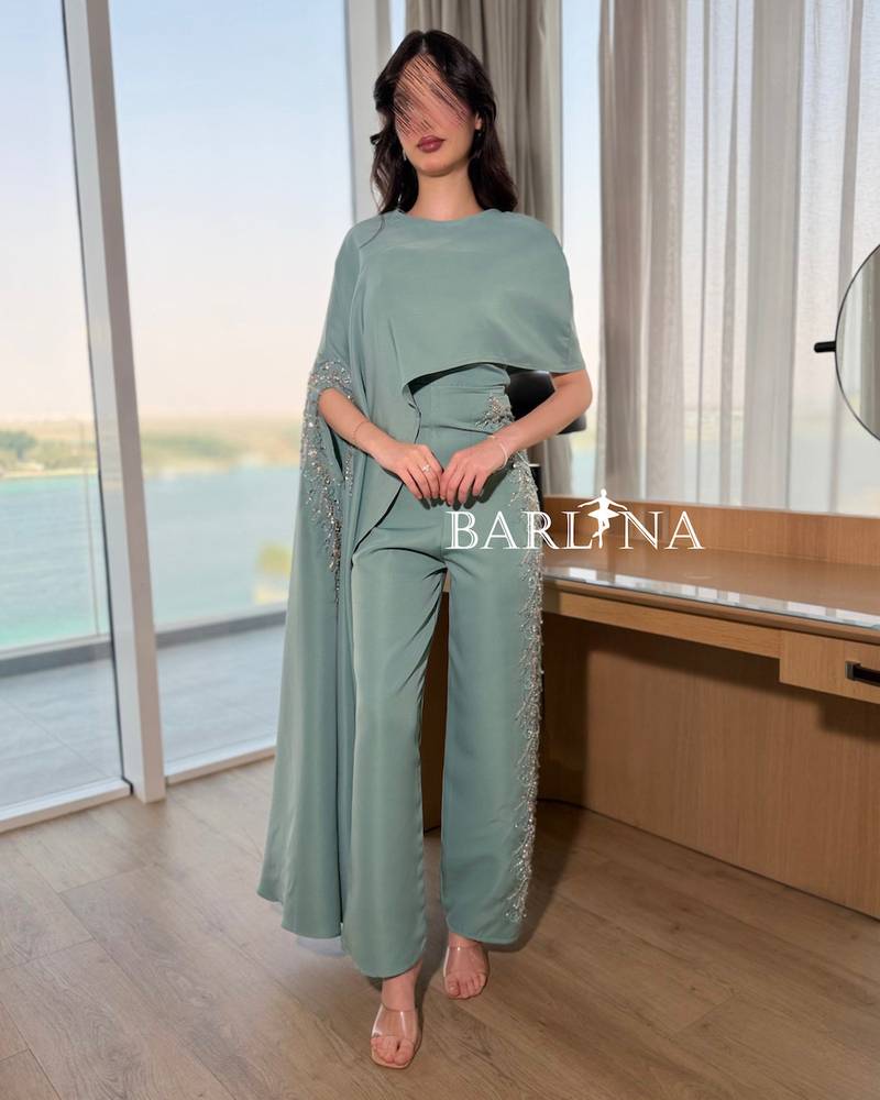 Tiffany jumpsuit with a side cape and shimmering embroidery