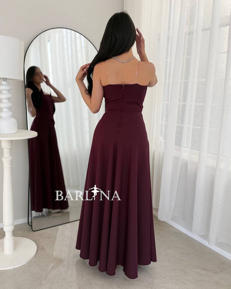 A flowing burgundy dress with a draped knot