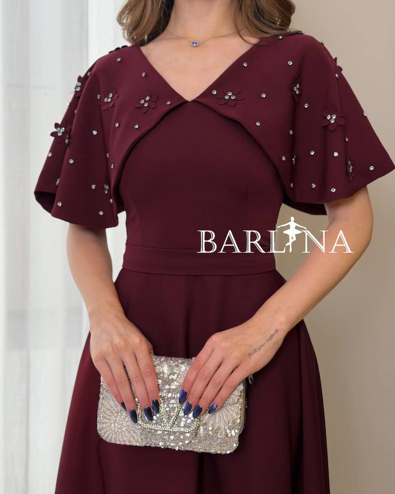 A soft, burgundy flared dress with delicate details
