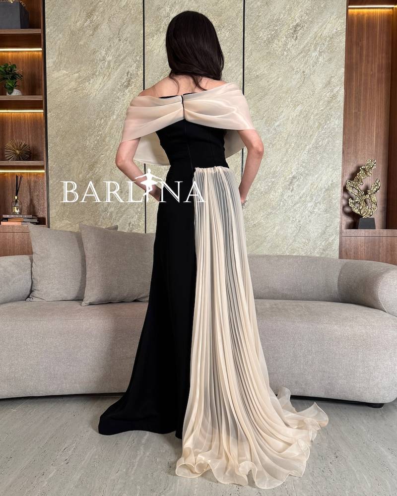 Luxurious black dress with beige shoulders and train