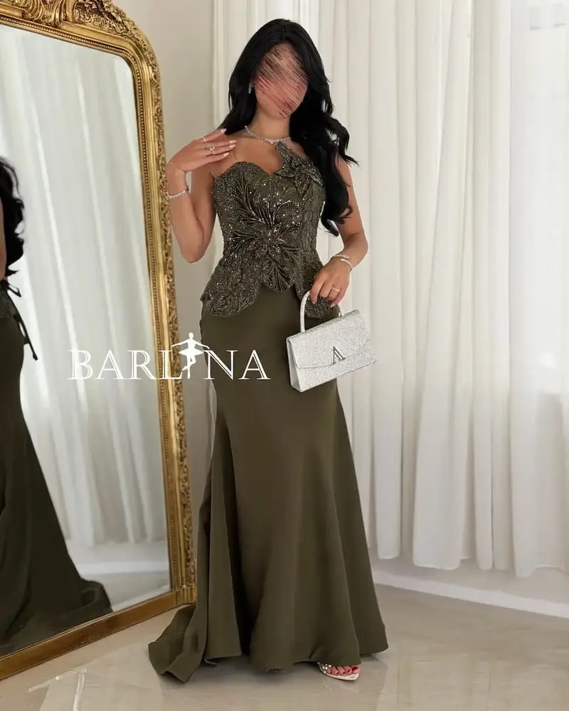 Olive green dress with prominent embroidery details