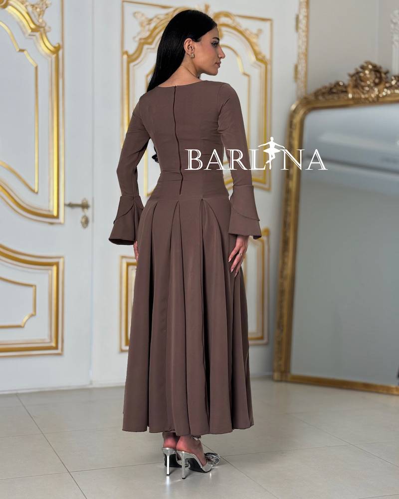 A brown dress with elegant decorative touches at the waist.