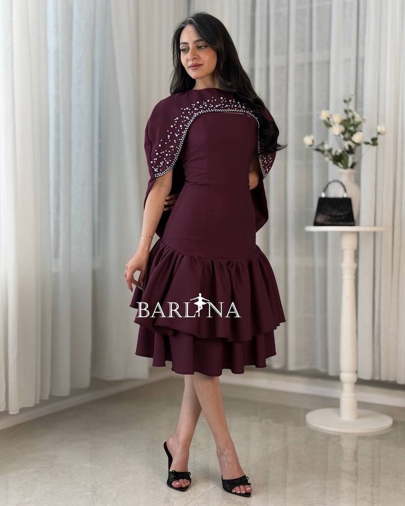 A short dress adorned with pearl details