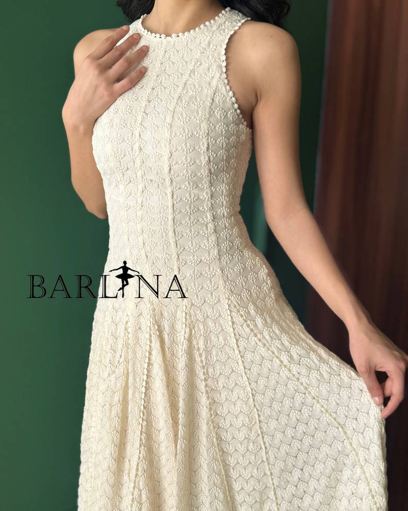 Soft off-white sleeveless dress with a flowing silhouette