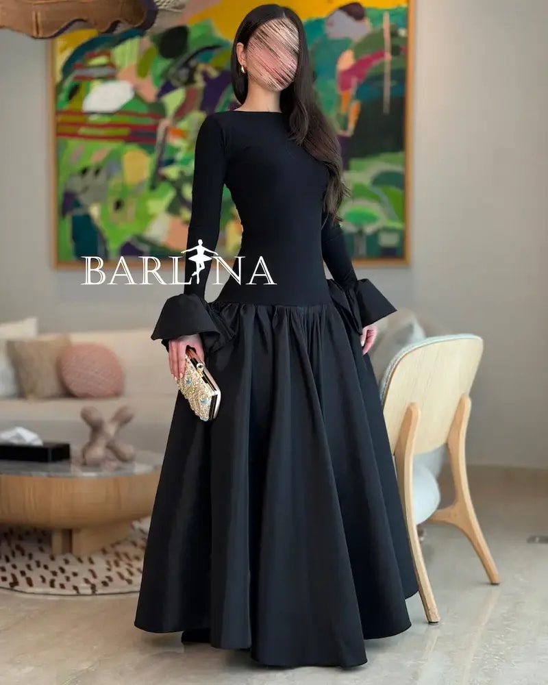 Elegant black dress with a high-cut top and long sleeves