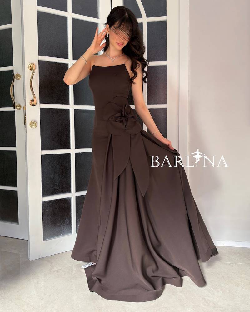 A brown dress with an elegant design and a flowing train