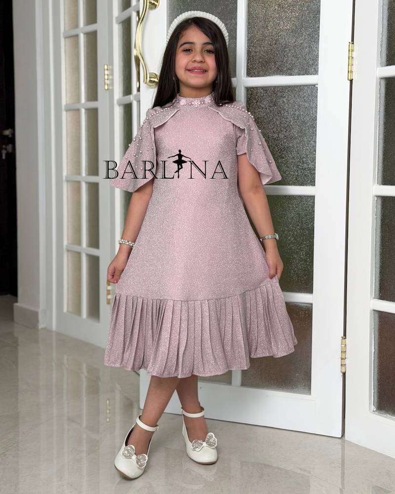 A shiny dress with a straight cut and a ruffled hem.