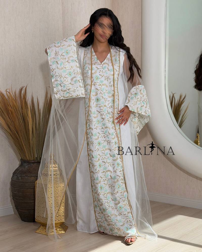 White jalabiya with gold embroidery and turquoise accents