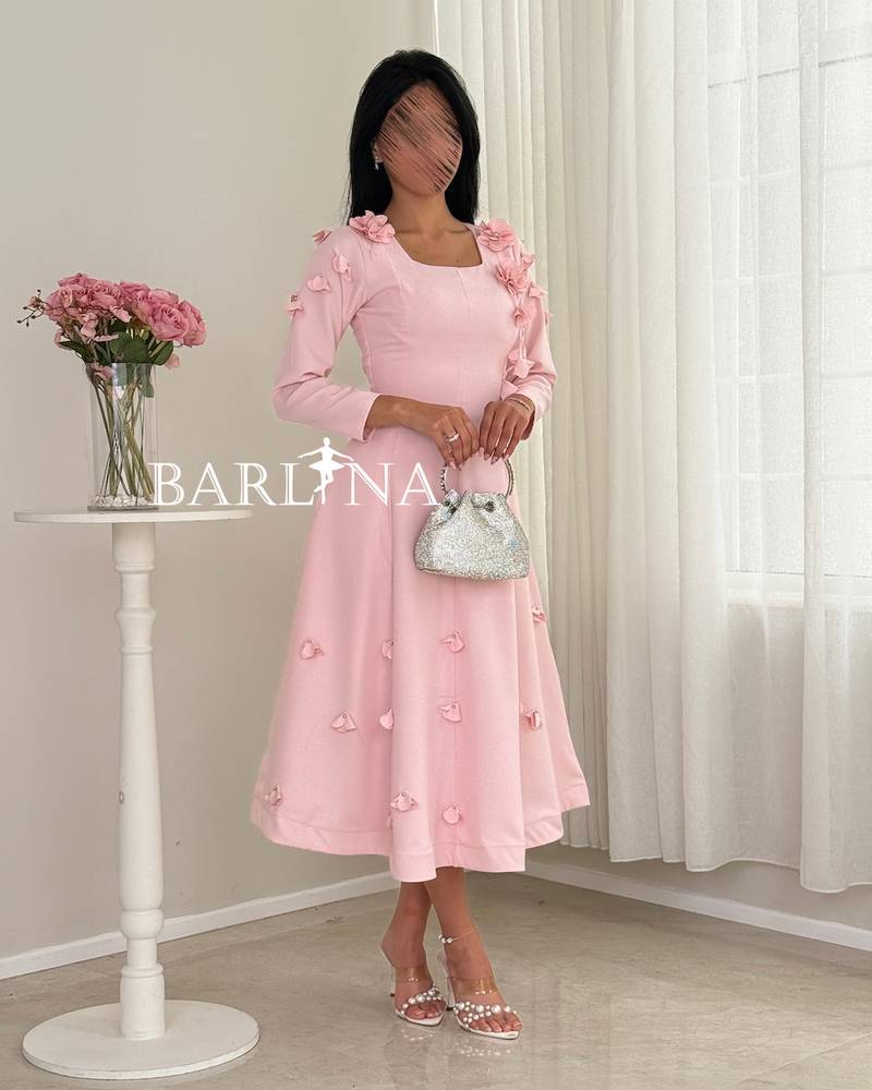 A soft pink midi dress with a sophisticated, feminine cut.