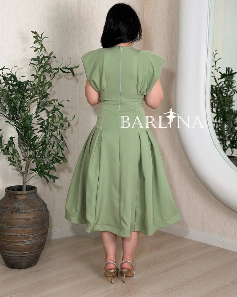 Olive green dress with a flower embroidery in the center