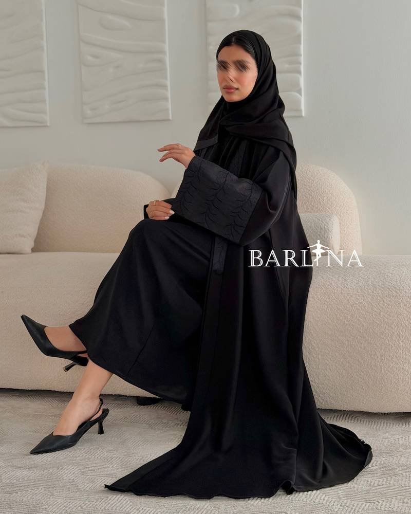 Black abaya with a flowing design and light embroidery