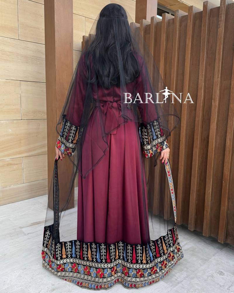 Red jalabiya with colorful traditional embroidery