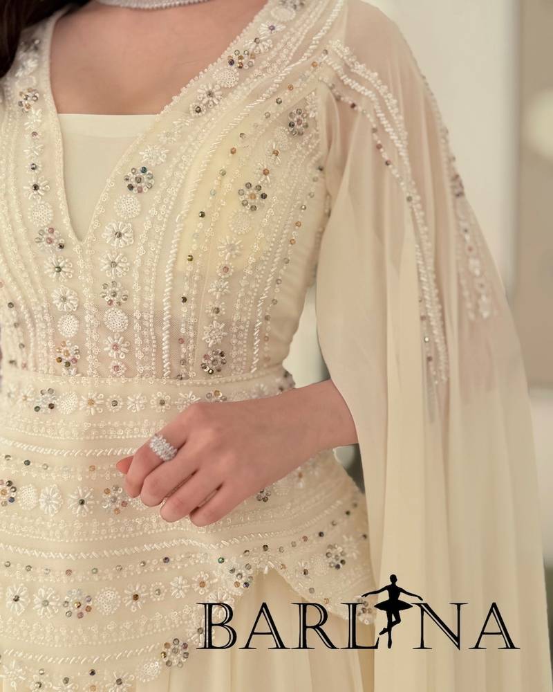 Off-white dress with a royal design and a long cape