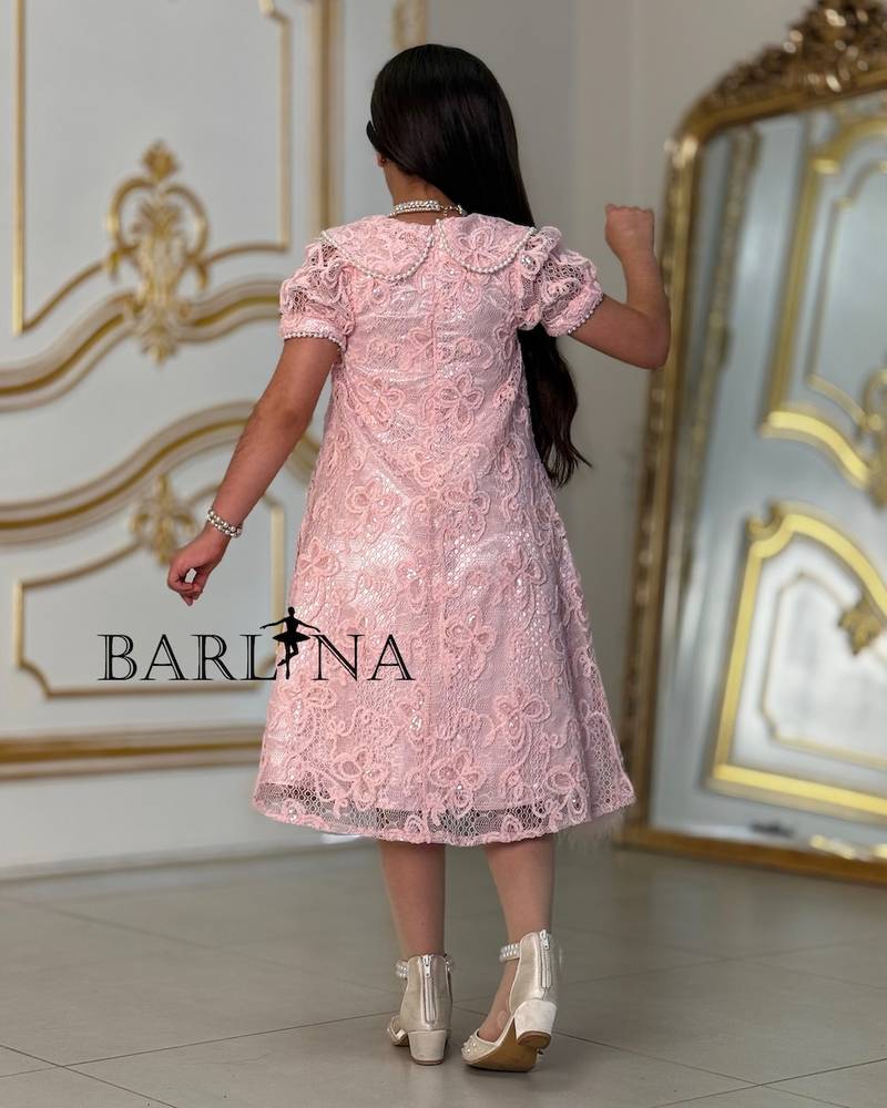 A soft girl's dress with lace and feather trim