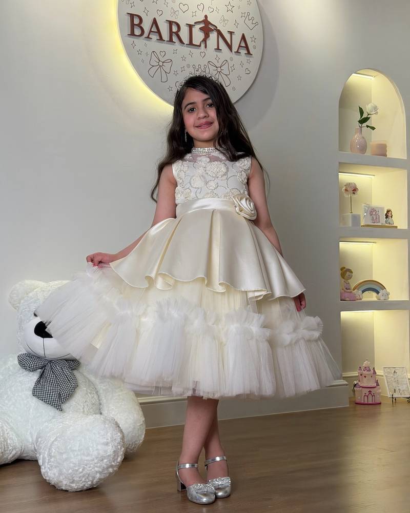 Girls' dress with elegant tiers and a side rose