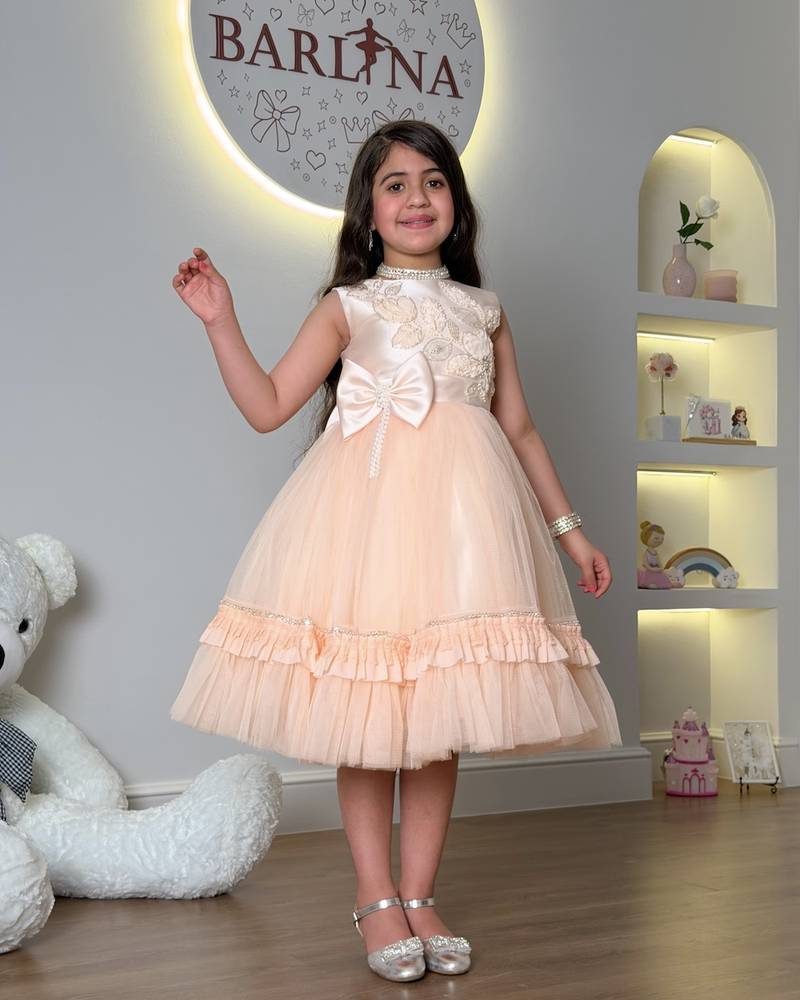 Girls' peach tulle dress with a large bow