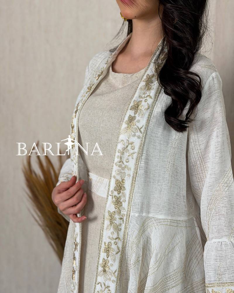 A soft jalabiya with an outer abaya featuring a gold pattern