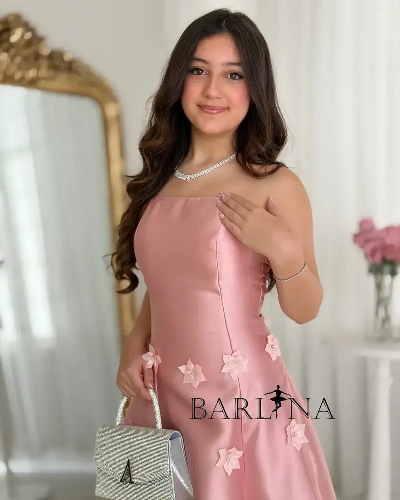 A pink dress with floral details for the age-confusing occasion.
