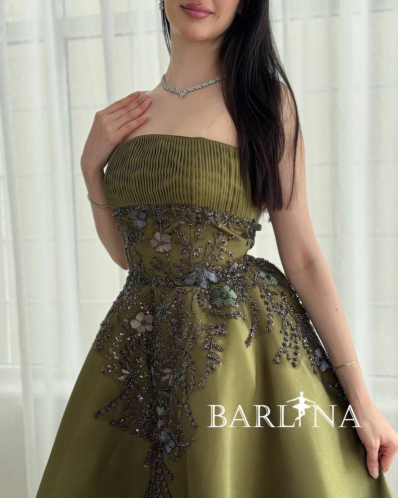 Long green evening dress with a ruffled bodice