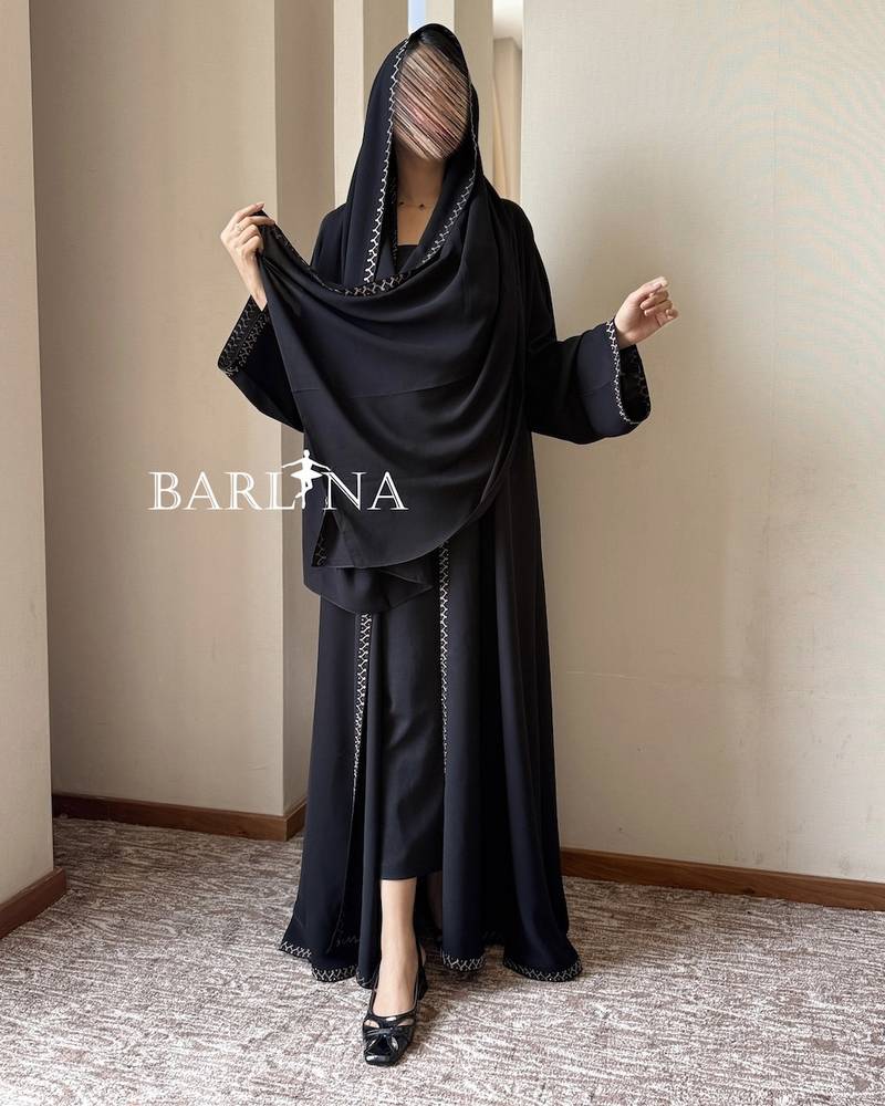 Black abaya with geometric embroidery on the edges