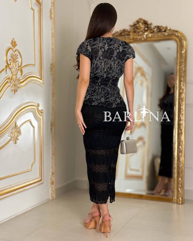 Set with a floral blouse and black stretch skirt