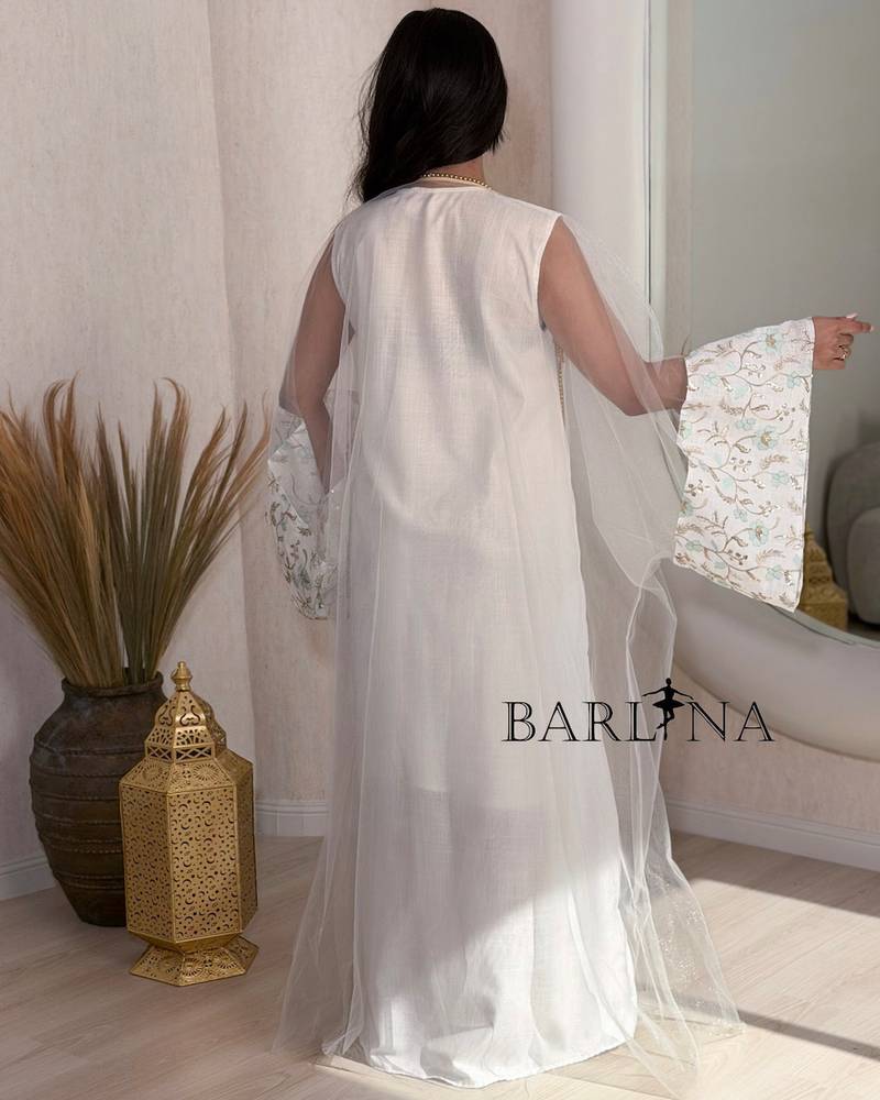 White jalabiya with gold embroidery and turquoise accents