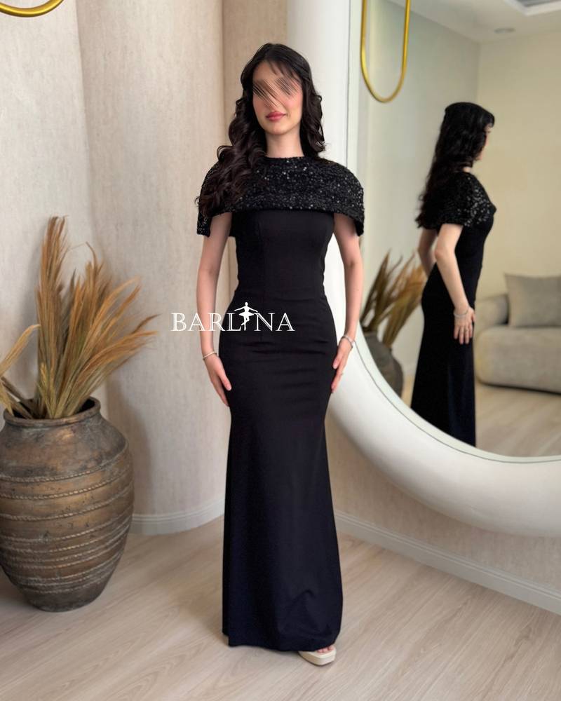 Classic black dress with a short sequined cape