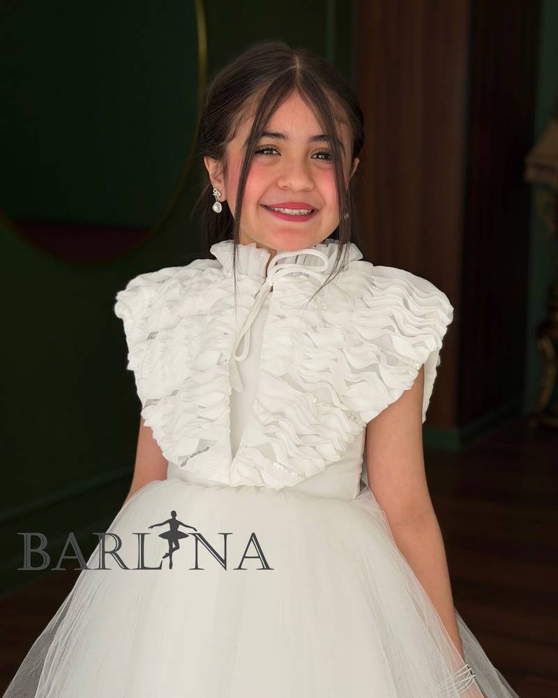 White girl's dress with a large ruffled shoulder