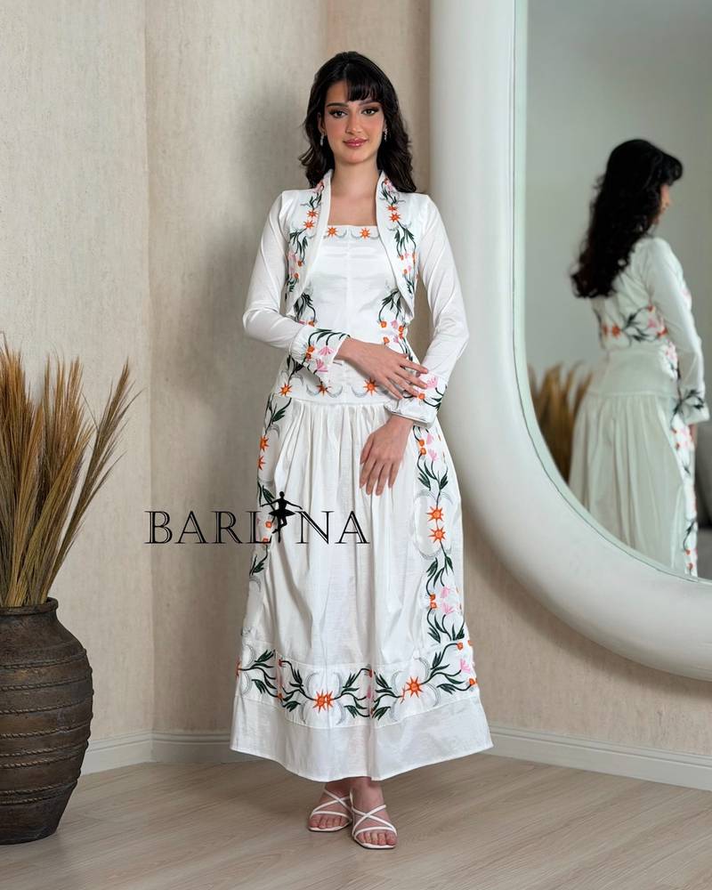A soft white dress with colorful floral embroidery