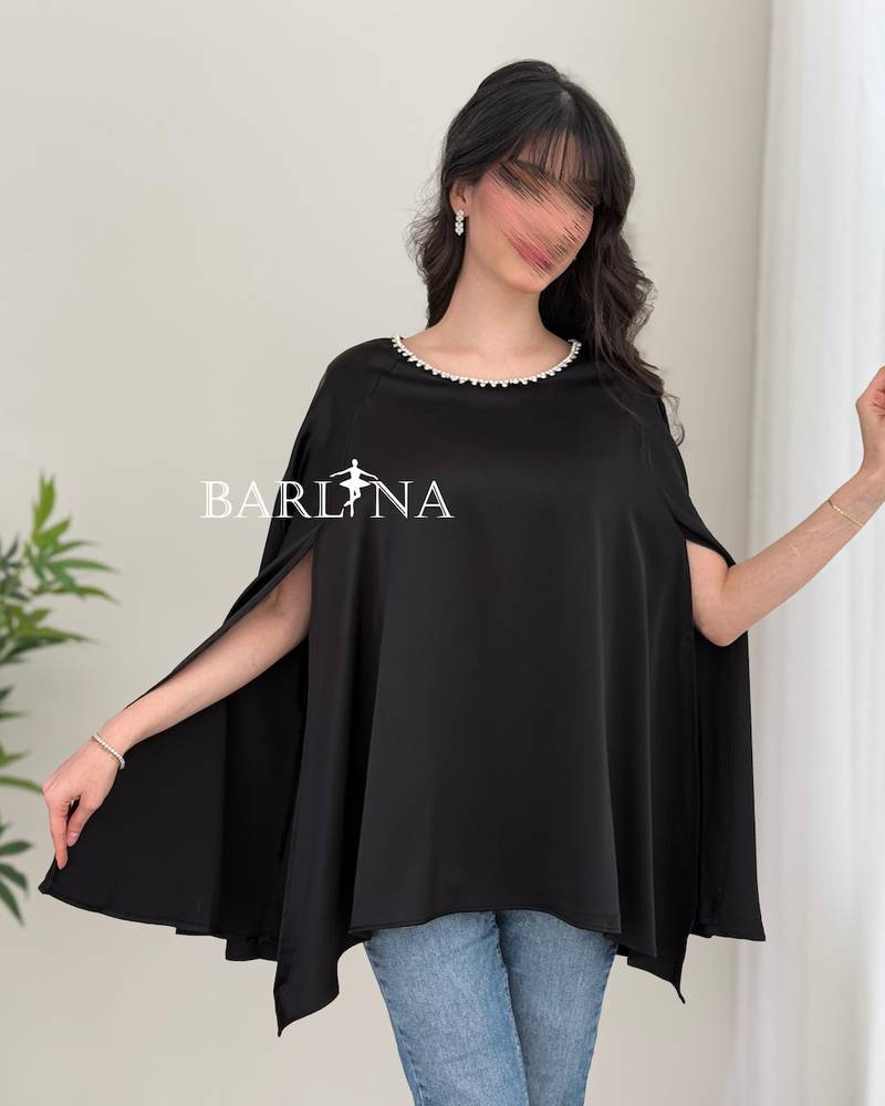 A soft blouse adorned with a pearl trim