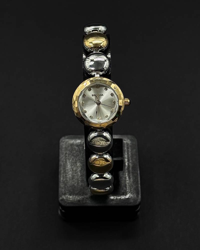 An elegant wristwatch with an oval gemstone design
