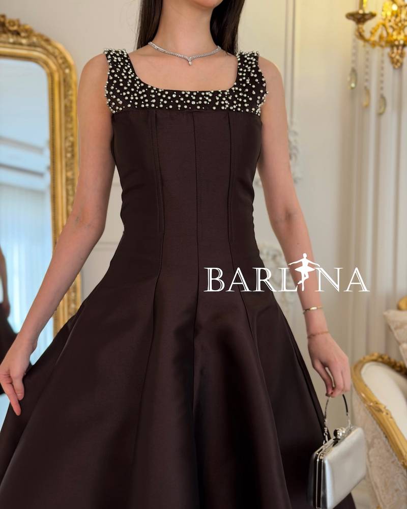 Brown sleeveless dress adorned with pearls