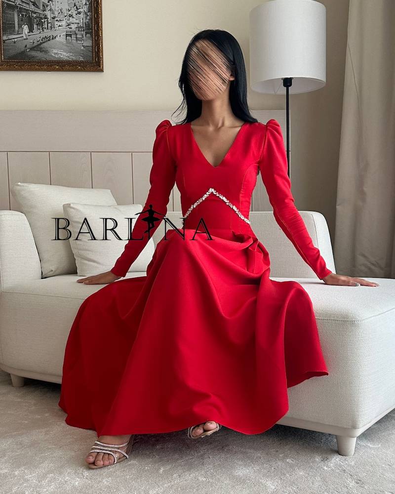 Classic red dress decorated with crystals with long sleeves