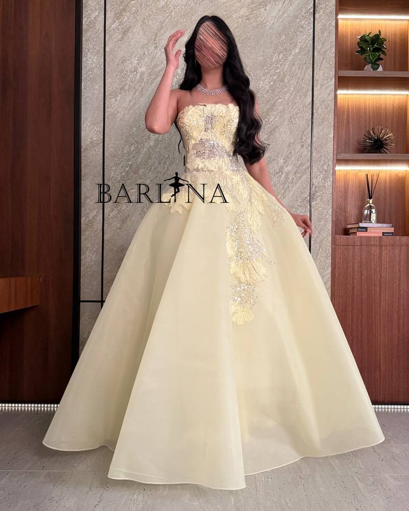 Light yellow evening dress embroidered with luxurious details